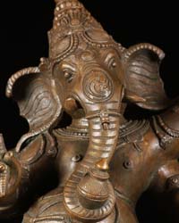 Ganesh murti trunk hanging in the center and curled to the left 