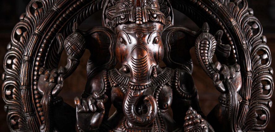 Wooded Ganesh Sculpture seated under arch