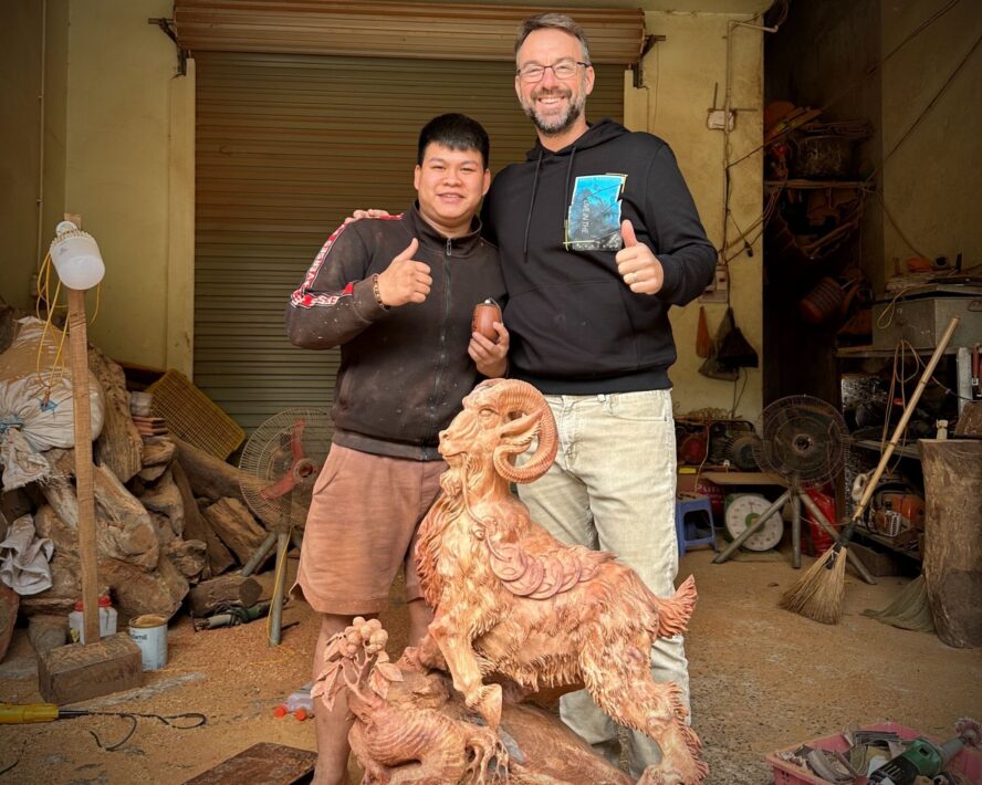 Kyle with wood artisan in Vietnam