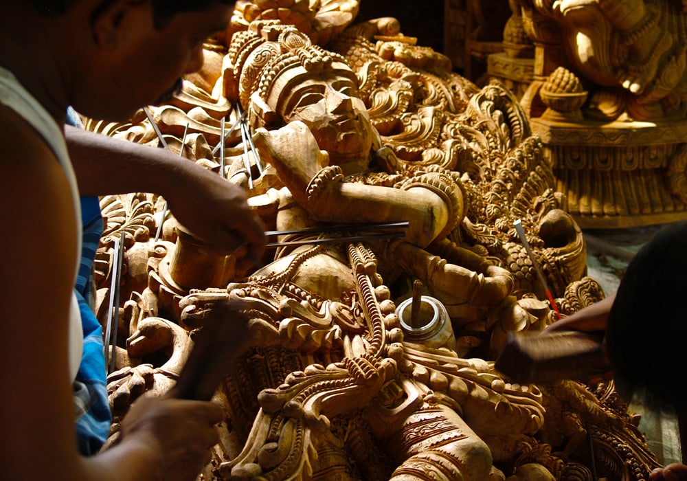 Wood worker in Tamil Nadu carving Krishna statue