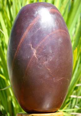 Deep Red and Purple Narmada Shiva Lingam with Lines Representing Shiva as a Pillar of Fire 12" Deep Red and Purple Narmada Shiva Lingam with Lines Representing Shiva as a Pillar of Fire 12"