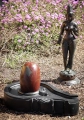 Narmada Shiva Lingam with Red and Grey Marbling on Black Stone Yoni Base 24"